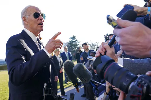 President Joe Biden talks with reporters on the South Lawn of the White House in Washington, Monday, Jan. 30, 2023, after returning from an event in Baltimore on infrastructure. (AP Photo/Susan Walsh)