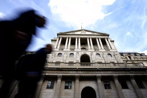 Pedestrians walk past The Bank of England in London, Thursday, Sept. 22, 2022. Britain's central bank is under pressure to make another big interest rate hike Thursday. Inflation in the United Kingdom is outpacing other major economies, but the U.S. Federal Reserve and other banks are moving faster to get prices under control. (AP Photo/Kirsty Wigglesworth)