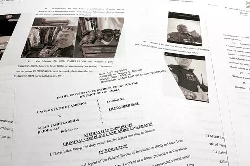 The affidavit to support the arrest of Arian Taherzadeh and Haider Ali is photographed Wednesday, April 6, 2022. Federal prosecutors have charged the two men they say were posing as federal agents, giving free apartments and other gifts to U.S. Secret Service agents, including one who worked on the first lady's security detail. Both were taken into custody as more than a dozen FBI agents charged into a luxury apartment building in Southeast Washington on Wednesday evening. (AP Photo/Jon Elswick)
