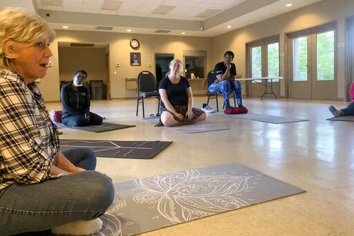 Participants in a six-week mindfulness course put on by East St. Tammany Habitat for Humanity and the Northshore Community Foundation gather in Slidell, La. (Kentrell Jones via AP)