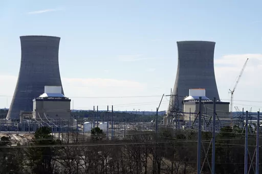 Units 3, left, and 4 and their cooling towers stand at Georgia Power Co.'s Plant Vogtle nuclear power plant, Jan. 20, 2023, in Waynesboro, Ga. Residential customers of Georgia's largest electrical utility could see their bills rise another $9 a month to pay for a new nuclear power plant under a deal announced Wednesday, Aug. 30. Georgia Power Co. said customers would pay $7.56 billion more for Plant Vogtle construction costs under the agreement with utility regulatory staff. (AP Photo/John Bazem