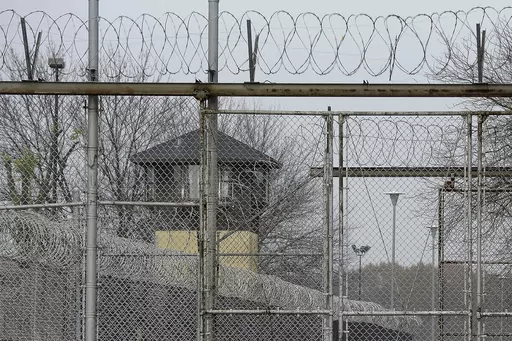 Security fences surround the Illinois Department of Corrections' Logan Correctional Center, Nov. 18, 2016, in Lincoln, Ill. Illinois Gov. J.B. Pritzker's administration has retained a contentious choice for providing medical care to prison inmates, awarding Wexford Health Sources a 10-year, $4.16 billion contract despite high vacancy rates, complaints of substandard care and lawmakers' agitation to find a replacement. (AP Photo/Seth Perlman, File)
