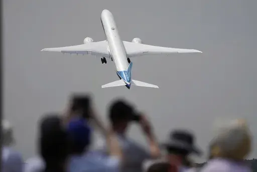 A Boeing 777X plane takes off at the Farnborough Air Show fair in Farnborough, England, on July 18, 2022. The cost of your next flight is likely to go up. That's the word from the International Air Transport Association, which held its annual meeting Monday June 3, 2024 in Dubai, home to the long-haul carrier Emirates. (AP Photo/Frank Augstein, File)