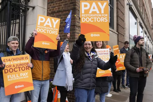 Junior doctors hold placards on a picket line outside St Mary's Hospital in London, Tuesday, March 14, 2023. Unions representing hundreds of thousands of nurses, ambulance crews and other health care workers in England reached a deal Thursday, March 16, 2023, to resolve months of disruptive strikes for higher wages, though the pact didn't include doctors. (AP Photo/Alastair Grant, File)