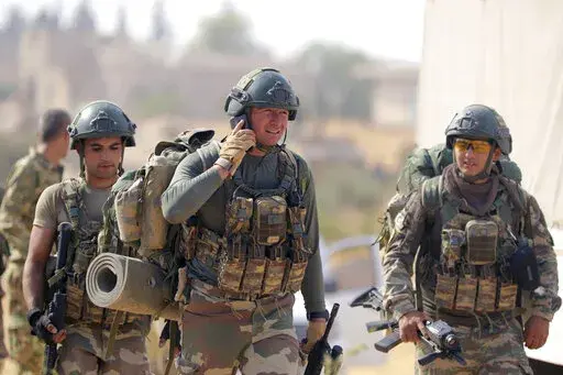Turkish troops deploy in Syria's northern region of Manbij, Syria, Oct. 14, 2019. Hardly a day passes in northern Syria without Kurdish fighters and opposition gunmen backed by Turkey exchanging gunfire and shelling and concerns are rising that the situation will only get worse in the coming weeks with Ankara threatening to launch a new major operation along its southern border. (AP Photo, File)