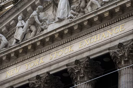 The New York Stock Exchange signage glistens in the noon sun on October 4, 2023, in New York. (AP Photo/J. David Ake, File)