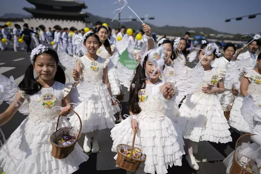 Children dressed as angels march during an Easter parade in Seoul, South Korea, on April 9, 2023. A new law that went into effect Wednesday, June 28, formalizes the international age-counting method as standard in administrative and civil laws and encourages people to tally their own ages accordingly. The country's previous age-counting method made people a year or two older than they really are. (AP Photo/Lee Jin-man, File)