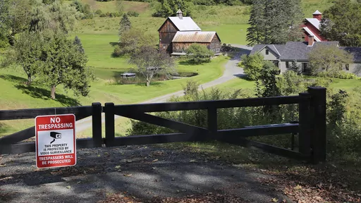 A no-trespassing sign hangs on a gate outside a private property, Thursday, Sept. 21, 2023, in Pomfret, Vt., that has become a destination for fall foliage viewers, clogging a narrow rural road. The town is closing the road to leaf peepers through mid-October because it says the increased traffic has caused significant safety, environmental, aesthetic and quality of life issues. (AP Photo/Lisa Rathke)