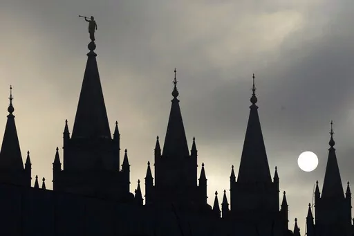 The angel Moroni statue atop the Salt Lake Temple is silhouetted against a cloud-covered sky, at Temple Square in Salt Lake City on Feb. 6, 2013. The U.S. Securities and Exchange Commission says, Tuesday, Feb. 21, 2023, The Church of Jesus Christ of Latter-day Saints and its investment arm will pay $5 million in fines. The SEC alleges the church used shell companies to obscure the size of the portfolio under the church's control.(AP Photo/Rick Bowmer, File)