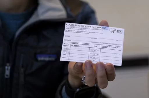 A nurse practitioner holds a COVID-19 vaccine card at a New York Health and Hospitals vaccine clinic in the Brooklyn borough of New York on Jan. 10, 2021. Now that COVID-19 vaccines are being distributed through the commercial markets instead of by the federal government in 2023, the Centers for Disease Control and Prevention won't be shipping out any more new cards. (AP Photo/Craig Ruttle, File)