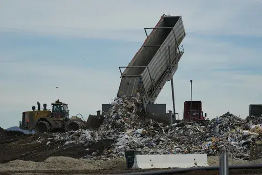 Trash is unloaded at the Otay Landfill in Chula Vista, Calif., Jan. 26, 2024. (AP Photo/Damian Dovarganes, File)