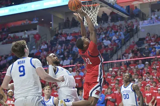 Mississippi guard Matthew Murrell (11) scores past Kentucky forward Ansley Almonor (15) during the first half of an NCAA college basketball game in Oxford, Miss., Tuesday, Feb. 4, 2025. (AP Photo/Bruce Newman)