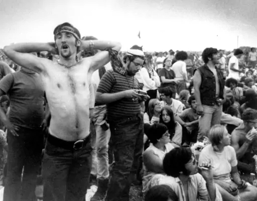 Music fans relax during a break in the entertainment at the Woodstock Music and Arts Fair, Aug. 16, 1969, in Bethel, N.Y. An estimated 450,000 people attended the Woodstock festival in August 1969, and most of that crowd was composed of teenagers or young adults now in the twilight of their lives. That ticking clock is why the Museum at Bethel Woods, based at the site of the festival, is immersed in a five-year project traveling around the United States recording the oral histories of people wer