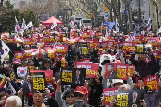 Supporters of impeached South Korean President Yoon Suk Yeol stage a rally to oppose his impeachment near the Constitutional Court in Seoul, South Korea, Tuesday, April 1, 2025. The letters read "Yoon Suk Yeol's immediate return and dismiss impeachment." (AP Photo/Ahn Young-joon