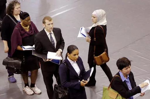 Job hunters line up for interviews at an employment fair sponsored by the New York State Department of Labor, Wednesday, Oct. 8, 2014 in the Brooklyn borough of New York. Just four months ago, city lawmakers overwhelmingly voted to require many ads for jobs in the nation's most populous city to include salary ranges, in the name of giving job applicants — particularly women and people of color — a better shot at fair pay. But on the cusp of implementing the measure, lawmakers voted Thursday 