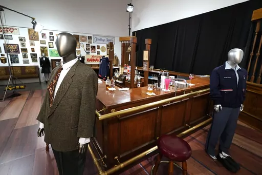 The bar used on the set of the television series "Cheers" and some costumes worn by actors on the sitcom are displayed, April 27, 2023, in Irving, Texas. The bar from the television series “Cheers” sold for $675,000 at auction over the weekend, garnering the highest bid among the nearly 1,000 props, costumes and sets from classic TV shows offered up from a collection amassed by one man over more than three decades. Heritage Auctions said that the items sold during its three-day event that wr