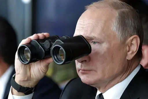 Russian President Vladimir Putin holds binoculars while watching the military exercises Center-2019 at Donguz shooting range near Orenburg, Russia, in Sept. 20, 2019. Russian President Vladimir Putin has warned that he wouldn't hesitate to use nuclear weapons to ward off Ukraine's attempt to reclaim control of its occupied regions that Moscow is about to absorb. (Alexei Nikolsky, Sputnik, Kremlin Pool Photo via AP, File)