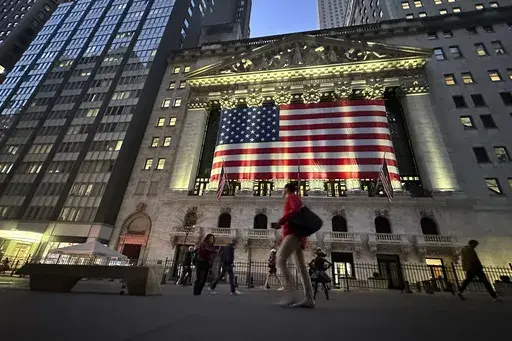 People pass the New York Stock Exchange on Nov. 5, 2024, in New York. (AP Photo/Peter Morgan, File)