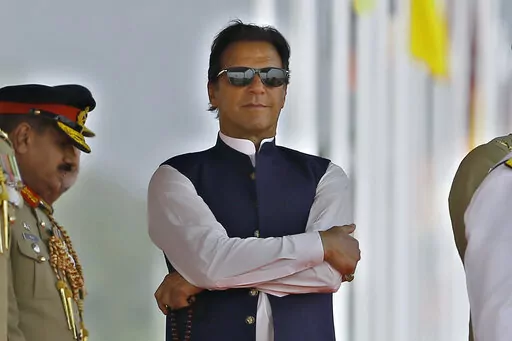 Pakistan's Prime Minister Imran Khan attends a military parade to mark Pakistan National Day, in Islamabad, Pakistan, Wednesday, March 23, 2022.  Pakistan’s prime minister, besieged by the opposition and abandoned by coalition partners, faces the greatest challenge of his political career on Thursday, March 31,  as debate begins on a no-confidence vote.(AP Photo/Anjum Naveed)