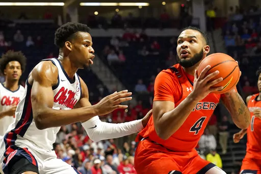 Auburn forward Johni Broome (4) looks for a shot while Mississippi forward Theo Akwuba (10) defends during the first half of an NCAA college basketball game in Oxford, Miss., Tuesday, Jan. 10, 2023. (AP Photo/Rogelio V. Solis)