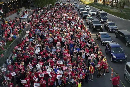 Members of the Culinary Workers Union rally along the Las Vegas Strip, Thursday, Aug. 10, 2023, in Las Vegas. After a marathon week of negotiations, the Las Vegas hotel workers union says it has reached a tentative deal with Wynn Resorts. It was the last contract the Culinary Workers Union needed to avoid a strike Friday, Nov. 10, 2023, and came after the union's tentative deals with Caesars Entertainment and MGM Resorts. (AP Photo/John Locher, File)