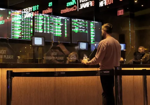 A customer makes a sports bet at the Borgata casino in Atlantic City N.J. on March 17, 2022 just before the March Madness NCAA college basketball tournament began. As March Madness gets underway, more people than ever now can legally bet on sports. A total of 38 states and the District of Columbia now allow some form of sports betting. (AP Photo/Wayne Parry, File)