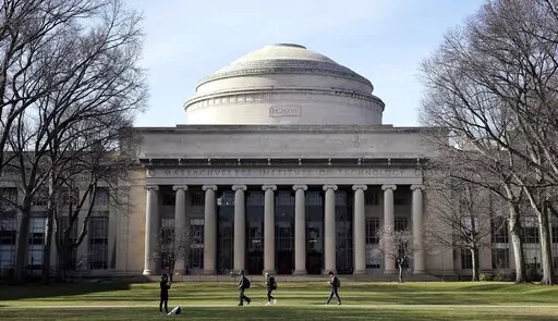 Students walk past the "Great Dome" atop Building 10 on the Massachusetts Institute of Technology campus, April 3, 2017, in Cambridge, Mass. The Justice Department dropped its case Thursday, Jan. 20, 2022 against MIT professor Gang Chen, charged last year with hiding work he did for the Chinese government, saying it "could no longer meet its burden of proof at trial." Chen was accused last year of concealing ties to Beijing while also collecting U.S. dollars for his nanotechnology research. (AP 