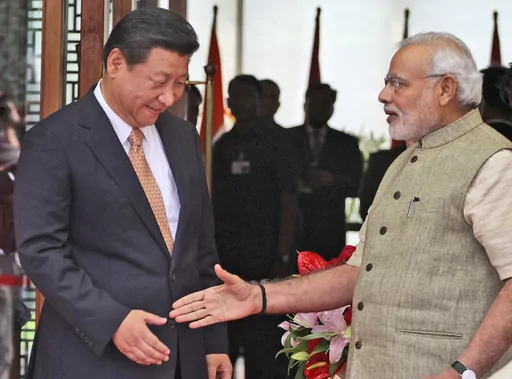 FILE- Indian Prime Minister Narendra Modi welcomes Chinese President Xi Jinping upon the latter's arrival at a hotel in Ahmadabad, India, Wednesday, Sept. 17, 2014. India is protesting a new Chinese map that lays claim to India’s territory ahead of next week's Group of 20 summit in New Delhi, a foreign ministry official said on Tuesday, Aug. 29, 2023, exacerbating tensions during a three-year military standoff between the two nations. The timing of the protest is key, as Chinese President Xi J