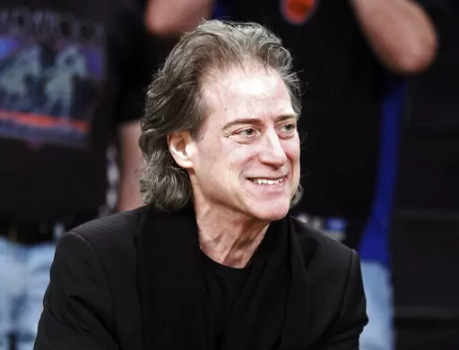 Comedian Richard Lewis attends an NBA basketball game in Los Angeles on Dec. 25, 2012. Lewis, an acclaimed comedian known for exploring his neuroses in frantic, stream-of-consciousness diatribes while dressed in all-black, leading to his nickname “The Prince of Pain,” has died. He was 76. He died at his home in Los Angeles on Tuesday night after suffering a heart attack, according to his publicist Jeff Abraham. (AP Photo/Alex Gallardo, File)
