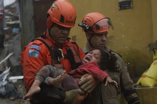 Rescue workers carry a 4-year-old girl who was rescued from her collapsed house after heavy rains in Petropolis, Rio de Janeiro state, Brazil, Saturday, March 23, 2024. (AP Photo/Bruna Prado)
