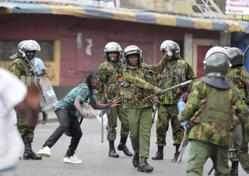 Police clash with a man during a protest by supporters of Kenya's opposition leader Raila Odinga over the high cost of living and alleged stolen presidential vote, in Nairobi, on March 20, 2023. The United States is praising Kenya's interest in leading a multinational force in Haiti. But weeks ago, the U.S. openly warned Kenyan police officers against violent abuses. Now 1,000 of those police officers might head to Haiti to take on gang warfare. (AP Photo/Brian Inganga, File)