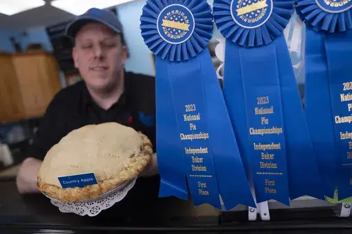 Manager Stephen Jarrett displays their National Pie Championships 1st place winning country apple pie at Michele's Pies, Wednesday, March 13, 2024, in Norwalk, Conn. (AP Photo/John Minchillo, File)