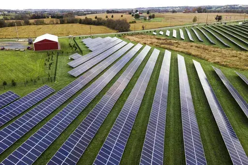 Farmland is seen with solar panels from Cypress Creek Renewables, Oct. 28, 2021, in Thurmont, Md. President Joe Biden plans to invoke the Defense Production Act to increase U.S. manufacturing of solar panels while declaring a two-year tariff exemption on panels from Southeast Asia. (AP Photo/Julio Cortez, File)