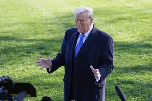 President Donald Trump speaks with reporters before departing on Marine One en route to New Jersey, Friday, Mar. 21, 2025, in Washington. (AP Photo/Mark Schiefelbein)