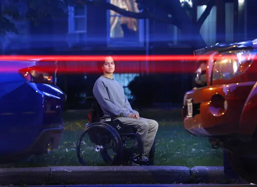 Jonathan Annicks poses for a portrait with his wheelchair in front of his home in Chicago on Oct. 13, 2016, just a few feet from where a lone gunman shot him, leaving him paralyzed sitting in his brother's parked car. Six years later Annicks has received a bachelor's degree in communications and media and has become a part-time peer advisor for patients at the same rehabilitation hospital where he was a patient. (AP Photo/Charles Rex Arbogast, File)