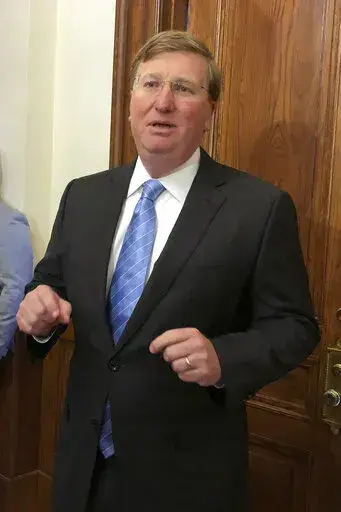 Mississippi Gov. Tate Reeves speaks Thursday, March 24, 2022, during a news conference outside his Capitol office in Jackson, Miss. The Republican says he wants legislators to phase out the state income tax. (AP Photo/Emily Wagster Pettus)
