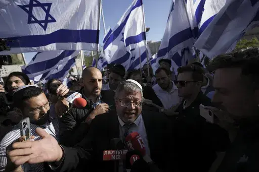 Israeli lawmaker Itamar Ben-Gvir, center, speaks to the media surrounded by right wing activists as they gather for a march in Jerusalem, April 20, 2022. Ben-Gvir visited Jerusalem’s most sensitive holy site Thursday, July 18, 2024, a move that could threaten the delicate Gaza cease-fire talks. (AP Photo/Ariel Schalit, File)