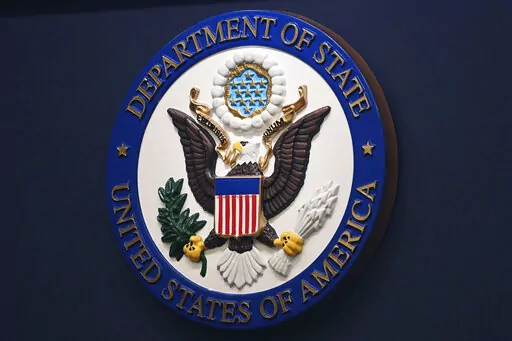 The State Department seal is seen on the briefing room lectern at the State Department in Washington, Jan. 31, 2022. Everyday Americans will be able to help refugees adjust to life in the U.S. in a program being launched by the State Department. The goal is to give private citizens a role in resettling the thousands of refugees who come to America every year. The State Department is calling the new program the Welcome Corps.(Mandel Ngan, Pool via AP, File)