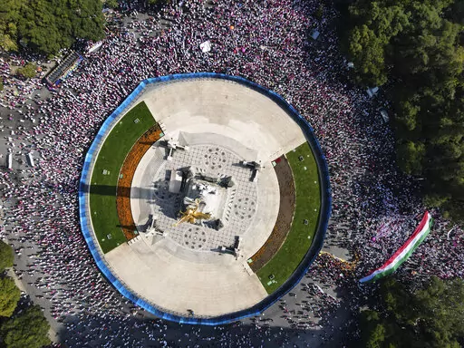 Citizen organizations rally at Mexico City's iconic "Angel of Independence" monument in support of Mexico's National Elections Institute as President Andrés Manuel Lopez Obrador pushes to overhaul it, Sunday, Nov. 13, 2022. (AP Photo/Marco Ugarte)