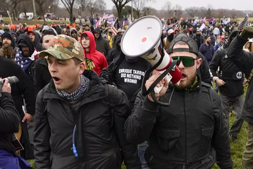 Proud Boys members Zachary Rehl, left, and Ethan Nordean, walk toward the U.S. Capitol in Washington, in support of President Donald Trump, Jan. 6, 2021. Federal prosecutors disclosed Wednesday, March 22, 2023, that a witness expected to testify for the defense at the seditious conspiracy trial of former Proud Boys leader Enrique Tarrio and four associates was secretly acting as a government informant for nearly two years after the Jan. 6 attack on the U.S. Capitol, a defense lawyer said in a co