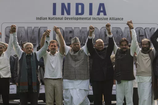 FILE- Leaders from the opposition INDIA alliance raise their hands together in a show of unity during a protest rally against the suspension of more than 140 lawmakers from the parliament, in New Delhi, India, Dec. 22, 2023. Last year more than two dozen opposition parties in India came together to take on Narendra Modi, one of the country's most popular prime ministers in generations. But the broad alliance, beset with ideological differences and personality clashes, is cracking at a crucial ti