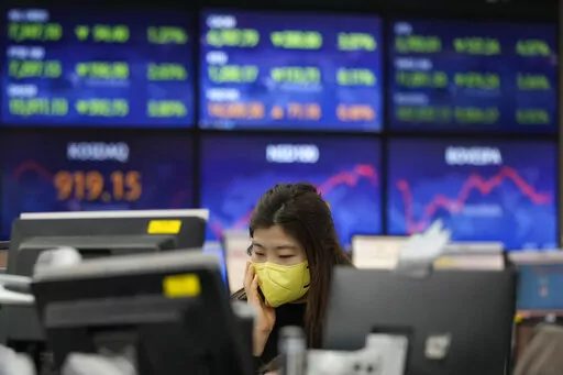A currency trader watches monitors at the foreign exchange dealing room of the KEB Hana Bank headquarters in Seoul, South Korea, Tuesday, Jan. 25, 2022. Asian shares skidded Tuesday following a volatile day on Wall Street. Inflation-fighting measures from the Federal Reserve and the possibility of conflict between Russia and Ukraine are overhanging markets.(AP Photo/Ahn Young-joon)