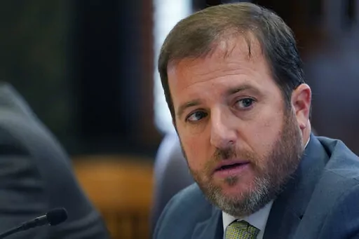 Senate Finance Committee chairman Josh Harkins, R-Flowood, explains a handout chart that outlines the purposed Tax Relief Act of 2022 during a Senate Finance Committee meeting at the Mississippi State Capitol in Jackson, Miss., Tuesday, Feb. 1, 2022. (AP Photo/Rogelio V. Solis)