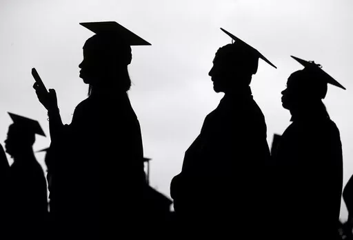 New graduates line up before the start of a community college commencement in East Rutherford, N.J., on May 17, 2018. President Joe Biden is expected to announce Wednesday Aug. 24, 2022 that many Americans can have up to $10,000 in federal student loan debt forgiven. (AP Photo/Seth Wenig, File)