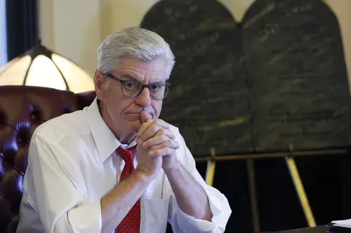 Gov. Phil Bryant ponders a response to a question regarding his legacy following a life of public service, while sitting in his Jackson, Miss., Capitol office, Jan. 8, 2020. (AP Photo/Rogelio V. Solis, file)