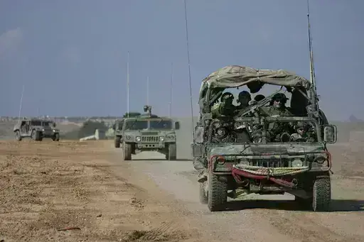 Israeli forces move near the Gaza Strip border in southern Israel, Thursday, Jan. 25, 2024. The army is battling Palestinian militants across Gaza in the war ignited by Hamas' Oct. 7 attack into Israel. (AP Photo/Ohad Zwigenberg)