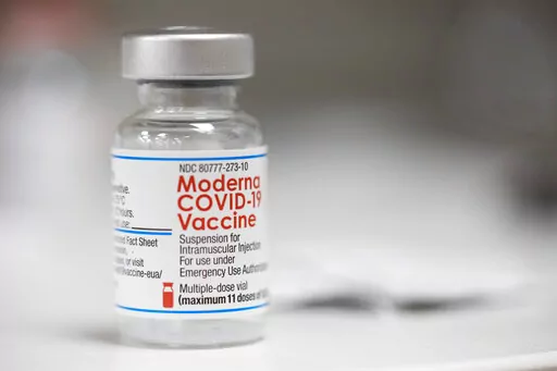 A vial of the Moderna COVID-19 vaccine is displayed on a counter at a pharmacy in Portland, Ore., Monday, Dec. 27, 2021. U.S. regulators have granted full approval to Moderna’s COVID-19 vaccine after reviewing additional data on its safety and effectiveness. The decision Monday, Jan. 31, 2022 by the Food and Drug Administration comes after many tens of millions of Americans have already received the shot under its original emergency authorization. Full approval means FDA has completed the same