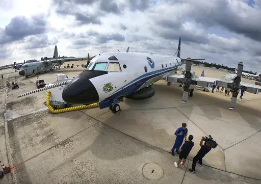 One of the National Oceanic and Atmospheric Administration's (NOAA) WP-3D Orion aircraft sits on the tarmac, with the U.S. Air Force Reserve 53rd Weather Reconnaissance Squadron's WC-130J, far left, during a stop at Orlando Sanford International Airport, in Sanford, Fla., Friday, May 10, 2024. The planes are "Hurricane Hunters" — flying science labs that navigates into the heart of tropical cyclones— collecting real-time storm data. (Joe Burbank /Orlando Sentinel via AP)