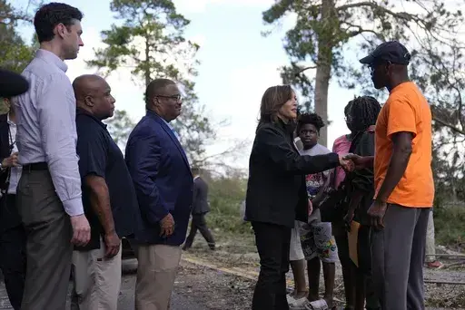 Democratic presidential nominee Vice President Kamala Harris greets people who were impacted by Hurricane Helene in Augusta, Ga., Wednesday, Oct. 2, 2024, as from left, Sen. Jon Ossoff, D-Ga., FEMA deputy direct Erik Hooks and Augusta Mayor Garnett Johnson watch. (AP Photo/Carolyn Kaster)