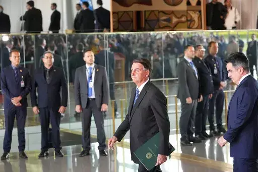 Brazilian President Jair Bolsonaro arrives to speak from his official residence of Alvorada Palace in Brasilia, Brazil, Nov. 1, 2022, the leader's first public comments since losing the Oct. 30 presidential runoff. Bolsonaro has dropped out of public view and has not disavowed the recent emergence of violence by his supporters who refuse to accept his narrow defeat. (AP Photo/Eraldo Peres, File)